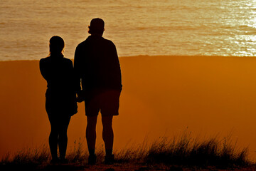 Silhouette of couple watching sunset 