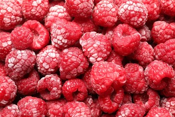 Frozen ripe raspberries as background, top view