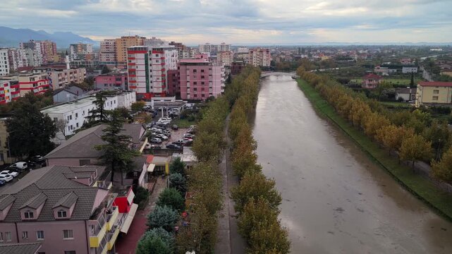Aerial video of Lezh&euml; with the Drin River dividing colourful city blocks from the broad green fields beyond.