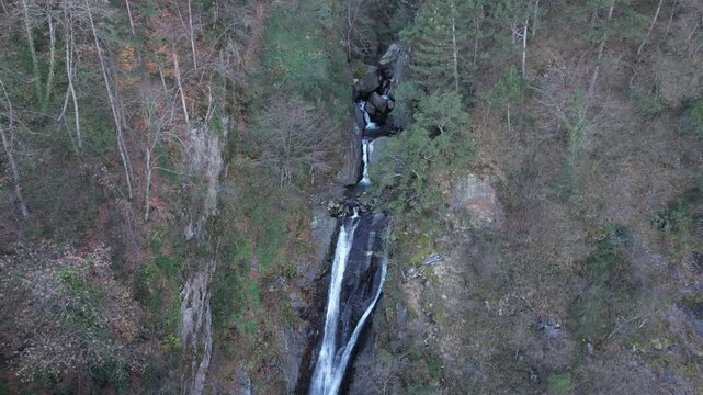 Drone Pull Back from Waterfall in Mountain Forest