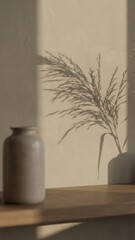 sunlight casts a shadow of a plant on a beige wall creating a minimalist aesthetic look