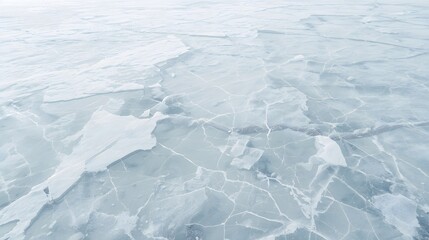 Frozen lake surface with cracked ice and frosty atmosphere in a cold winter landscape viewed from above