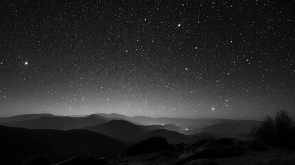 Awesome photo of monochrome landscape of starry night sky over mountain peaks.
