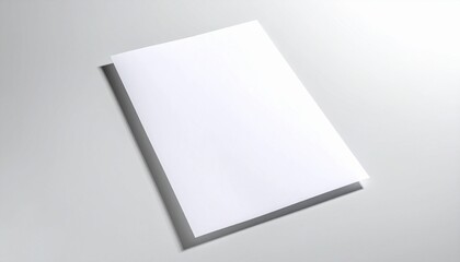 Blank white paper on a grey surface casting a shadow, ready for your creative design or message