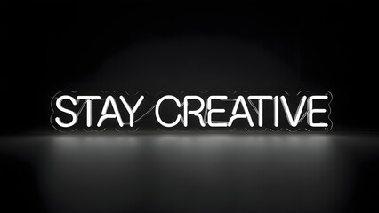 Stay creative neon sign displayed in a dark room