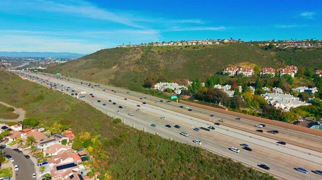 Aerial view of Mira Mesa neighborhood with freeway, houses, hills, and suburban layout in San Diego, California.
