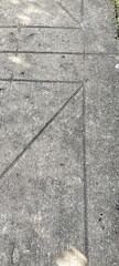 A top-down view of a concrete surface with a geometric seam or joint line