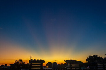 Sunset over the city with clouds in the blue sky background.