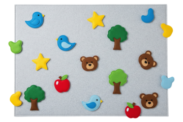 Grey felt board with colorful animal and nature fabric shapes on a transparent background