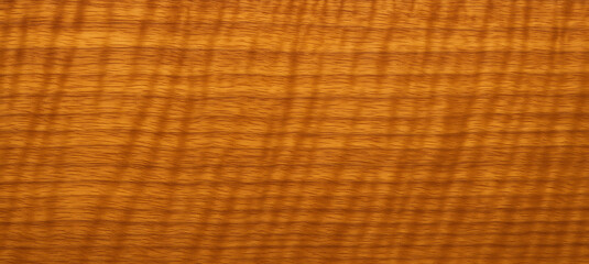 Warm curly maple wood texture background with natural wavy grain pattern, polished hardwood surface ideal for design, furniture, flooring, and luxury material concepts
