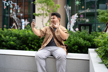 A professional male engages in mobile communication against a contemporary glass facade, illustrating modern connectivity.
