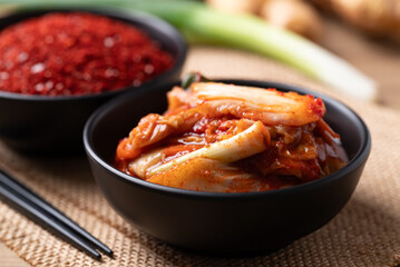 Kimchi cabbage in a bowl with ingredients, Korean food
