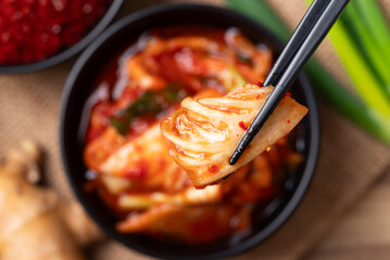 Kimchi cabbage in a bowl with chopsticks, Korean food, Top view