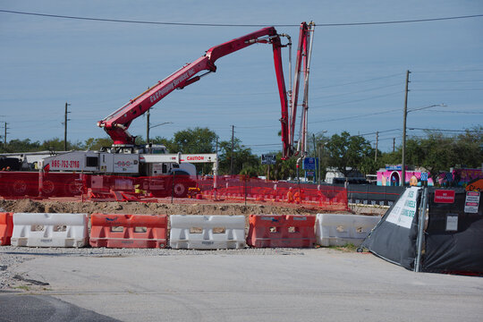 Construction Site With Cemex Cement Mixer Truck, Safety Fencing, And Worker In Hi-Vis Gear. Editorial Use Only, December 31, 2025. St. Petersburg , FL USA. Busy construction site featuring a cement mi
