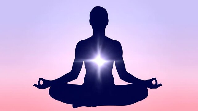 Silhouette of a Person Meditating with Glowing Heart Chakra.