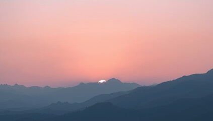 Obraz premium Serene Sunset Over Mountain Range with Soft Pink and Purple Sky