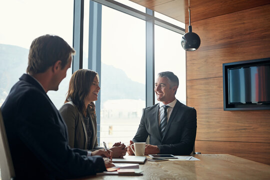 Smile, men and woman in office for consultation, legal advice or corporate negotiation with attorney. Advisor, lawyer team and people in meeting at law firm for discussion, interview or networking