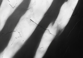 diagonal shadows cast across a cracked plaster wall creating a stark, dramatic and contemplative monochrome scene