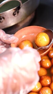 Gulab jamun or kaala jam indian dessert fried balls dipped in sugar syrup