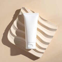 Minimalist beauty product white squeeze tube mockup displayed on sculpted wavy beige pedestal under sharp sunlight shadow