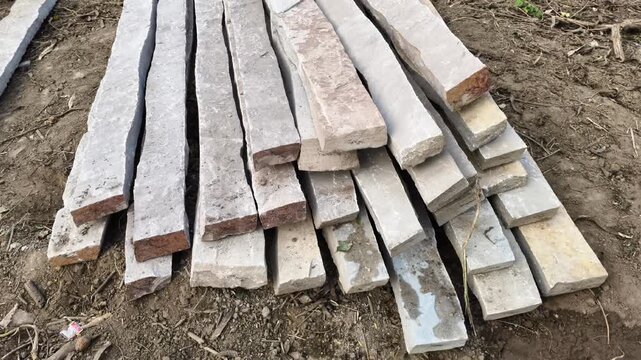 Stack of rectangular natural stone pillars for agricultural fencing and property boundary construction