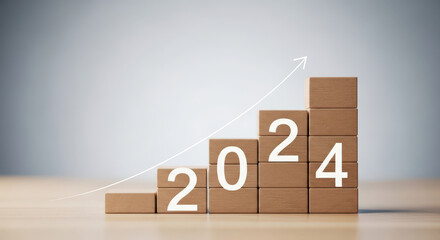 Growth blocks with number 2024 and arrow representing upward trend Business concept of business growth in upcoming year on wooden table background
