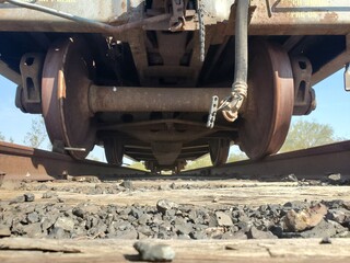 Wheels Underneath an Old Flatbed Train Car Rusting in the Arizona Desert