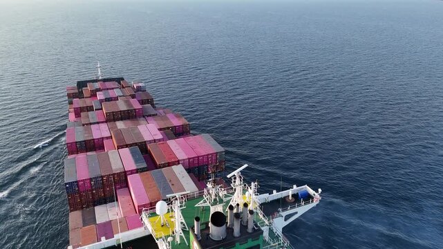 4K Aerial overhead view of large container cargo ship traveling over the ocean
