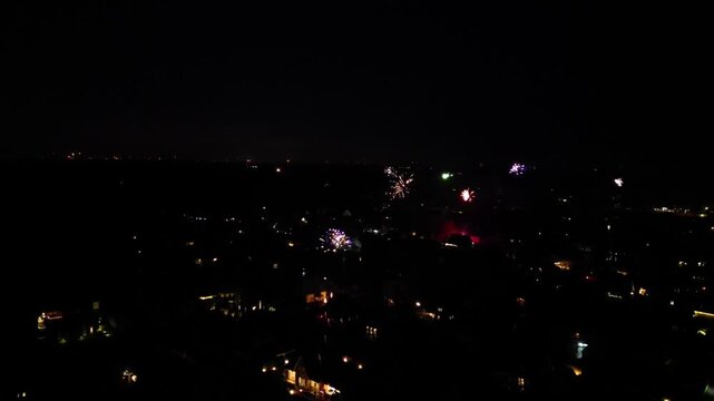 Cityscape at night, fireworks lights over a dark silhouette suggesting festive activities, New Year's Eve 2025, 27798 Hude, Lower Saxony, Germany