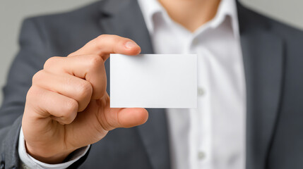 A businessman holding a blank business card, ready for networking and making connections.