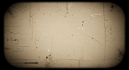 Vintage television screen with a scratched and worn beige surface, displaying a distressed texture with cracks and marks against a black background.