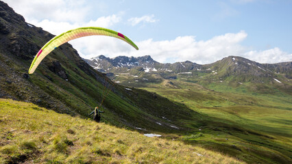 Paraglider taking off over Hatcher Pass in the Talkeetna Mountains near Wasilla Alaska United States