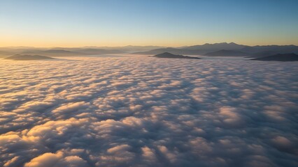 Breathtaking aerial view of clouds and mountains at sunrise