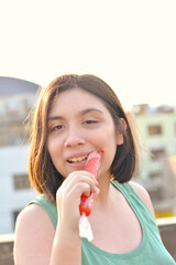Happy latin girl holding fruit ice.