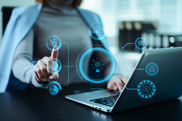 Business professional using a digital interface with data analytics, ecommerce, and innovation icons, representing modern technology