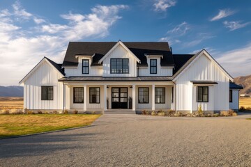 Modern farmhouse painted matte white with black framed windows steep rooflines and centered porch gravel driveway sweeps toward