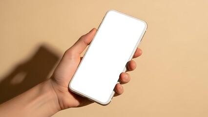 A hand holding a white smartphone with a blank screen