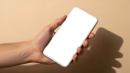 A hand holding a white smartphone with a blank screen