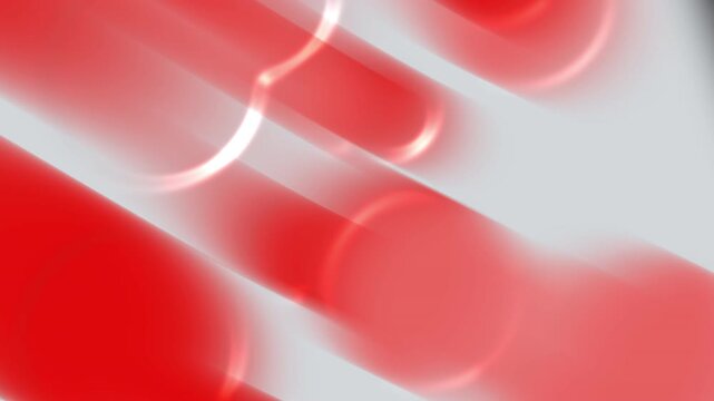Abstract blur of red cylindrical shapes against a grey background suitable for backgrounds, digital design, web graphics, and creative projects.