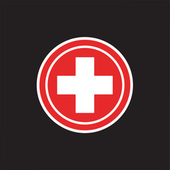 Fototapeta premium A bold red circular emblem featuring a white medical cross at the center, set against a solid black background. Ideal for first aid, emergency, or healthcare branding.