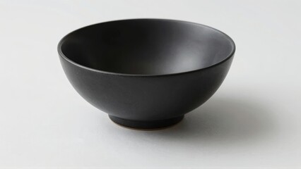 Black matte ceramic bowl on white surface