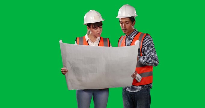 Caucasian workers with safety vest on green background