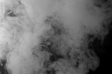 Wisps of white smoke isolated on a black background with space for text
