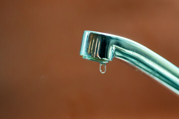 Leaking faucet with single drop of water falling