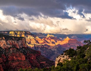 Fototapeta premium Expansive canyon landscape with sunlight breaking through dramatic clouds