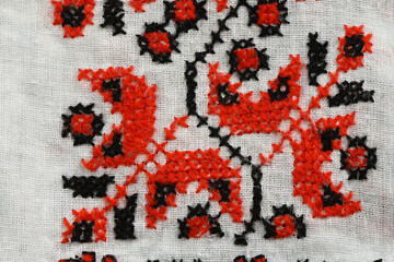 Detailed Close-up of Red and Black Traditional Cross-Stitch Embroidery Pattern