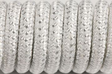 Close-up texture of coiled white braided nylon rope