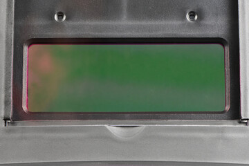 Green interior view of auto-darkening welding helmet lens