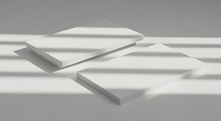 Three white rectangular objects casting shadows on a light surface.