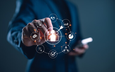 Businessman using digital interface to target customers. Marketing strategy, customer relationship management (CRM), data analytics and business growth through technology.